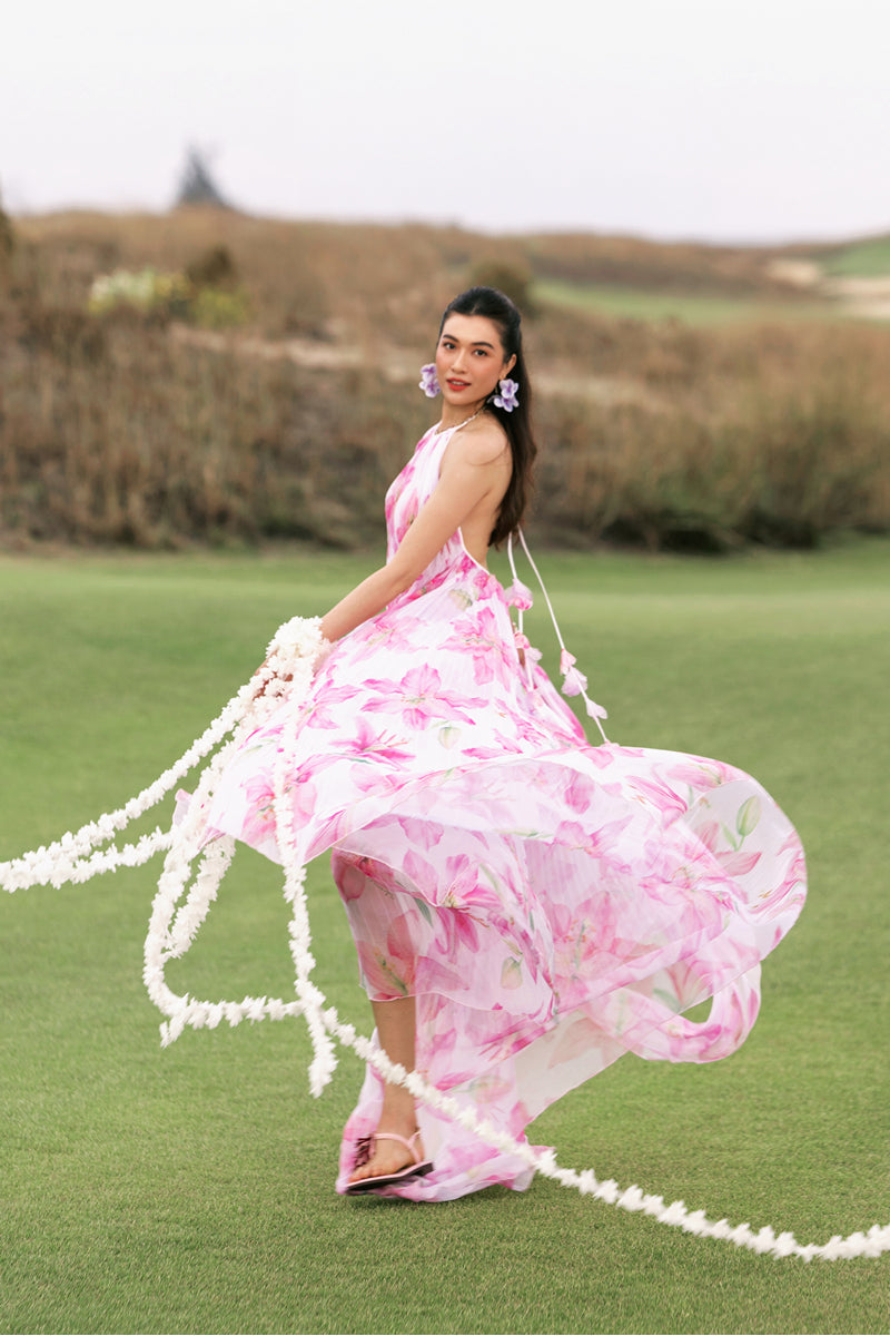 Valenciani multicolor halter neck pleated maxi dress displayed on a mannequin with flowing fabric and vibrant patterns.