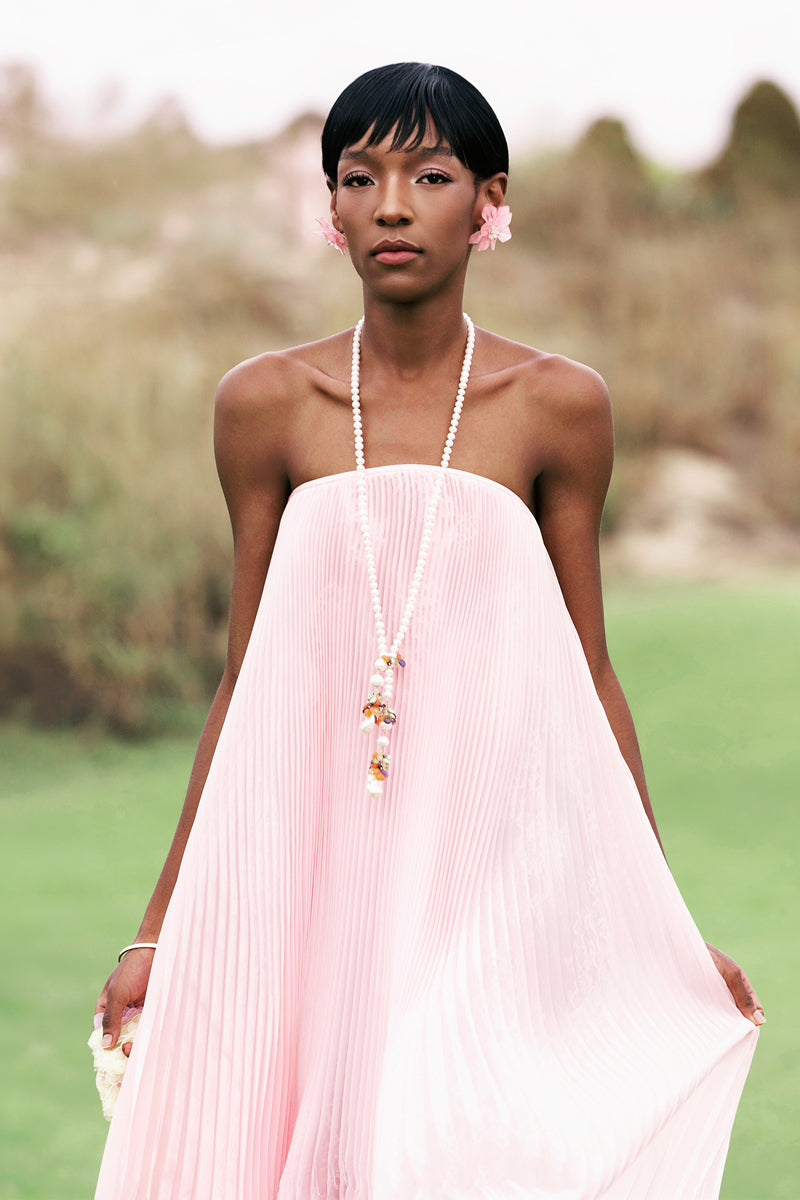 Pastel pink strapless pleated maxi dress by Valenciani, flowing design with a soft, elegant silhouette.