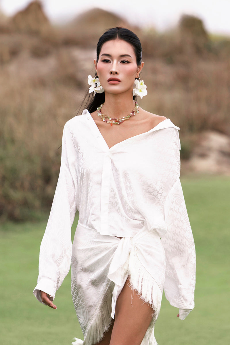 White silk shirt by Valenciani featuring a classic fit and smooth fabric, displayed on a hanger.