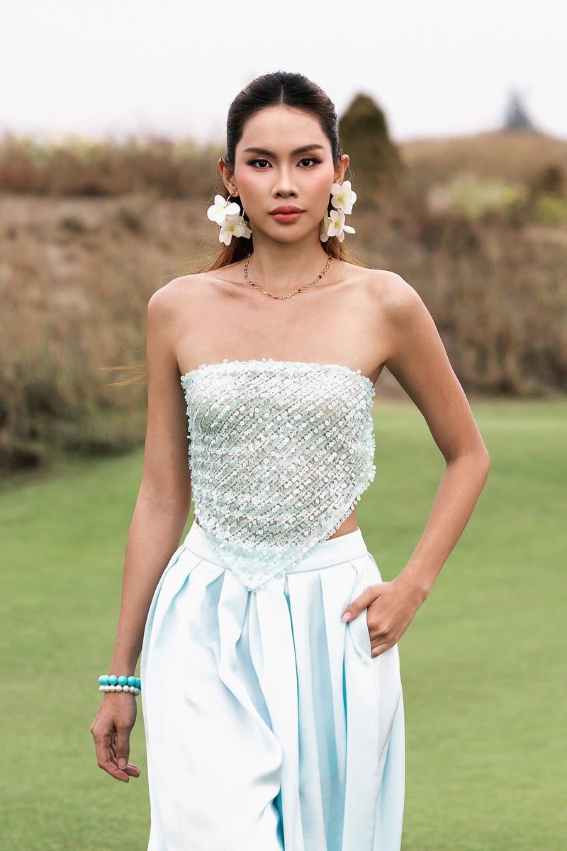 Sky blue balloon pants by Valenciani, featuring a loose fit and stylish design, shown on a model against a neutral background.