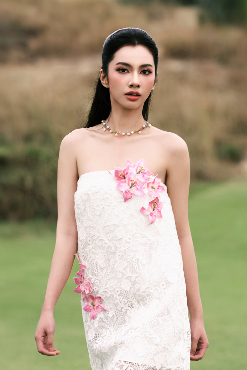 White strapless mini lace dress by Valenciani, featuring intricate lace details and a fitted silhouette.