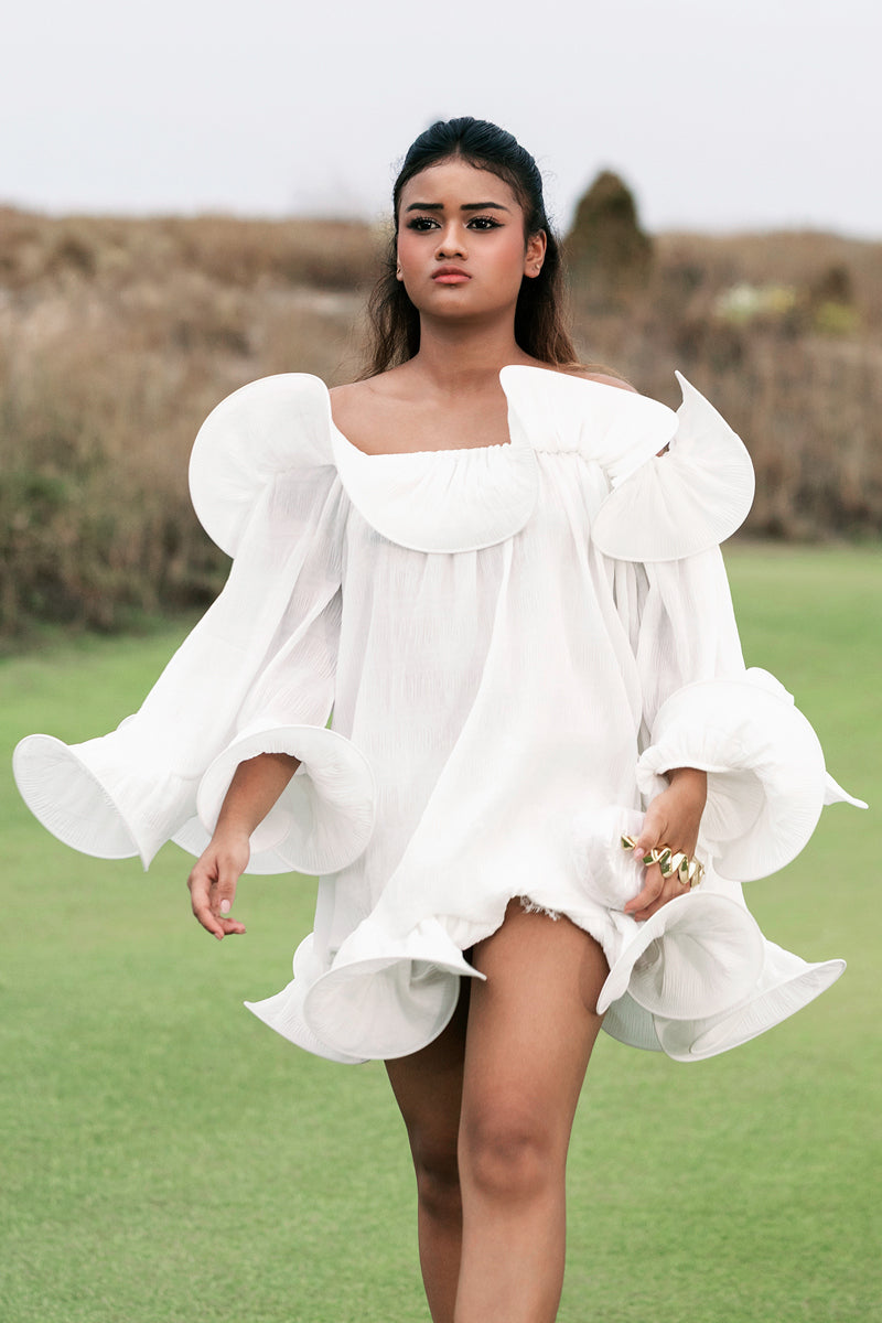 White Valenciani Origami Cloud mini dress with a fitted silhouette, displayed on a mannequin.