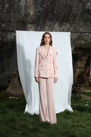 A pair of Aquarel Studio GILA trousers, stylish pants with a relaxed fit, shown in a natural fabric with a neutral color.