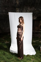 Aureal Studio Lily Glitter Skirt in Mirage Brown, a shiny maxi skirt with glittery fabric and flowy silhouette, displayed on a model.