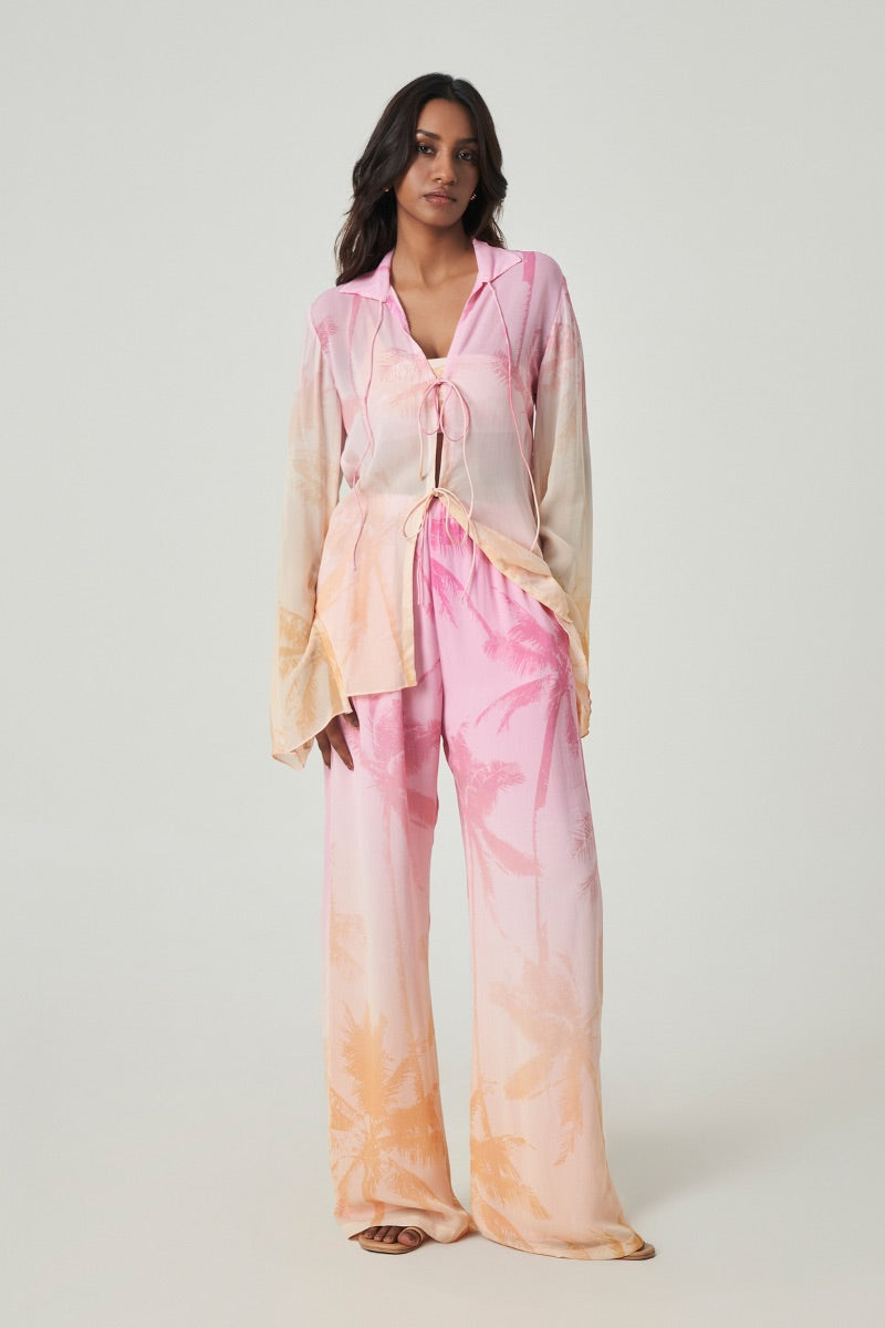 Light blue Merlette Afterglow shirt from Summer Away, featuring a relaxed fit and soft fabric, displayed on a hanger.