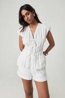 White DEIA Shorts by Summer Away, casual summer shorts with a relaxed fit and minimalist design, shown on a model.