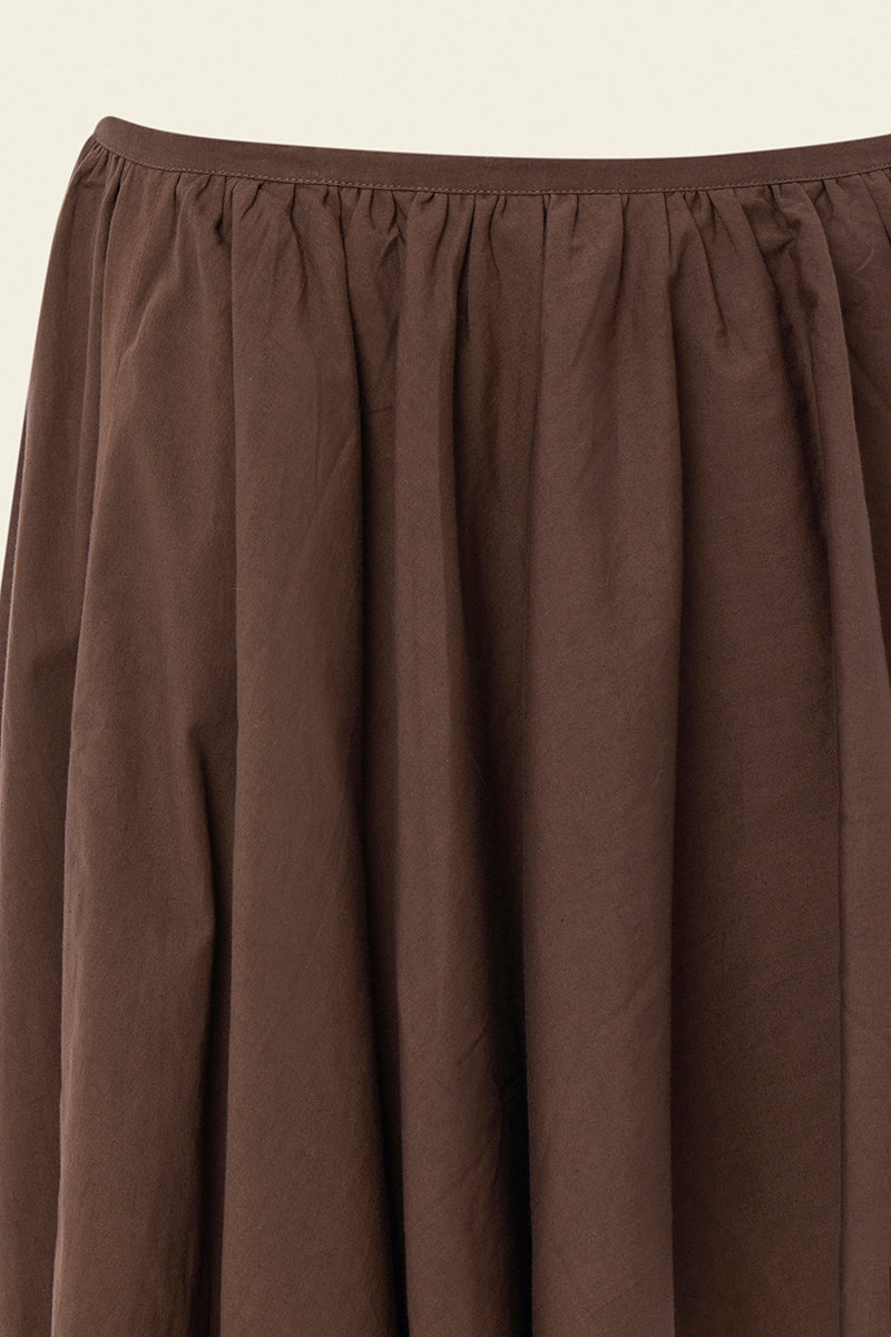 Brown modular mini skirt by IKINITA, showing close-up of the layered fabric and stylish design.