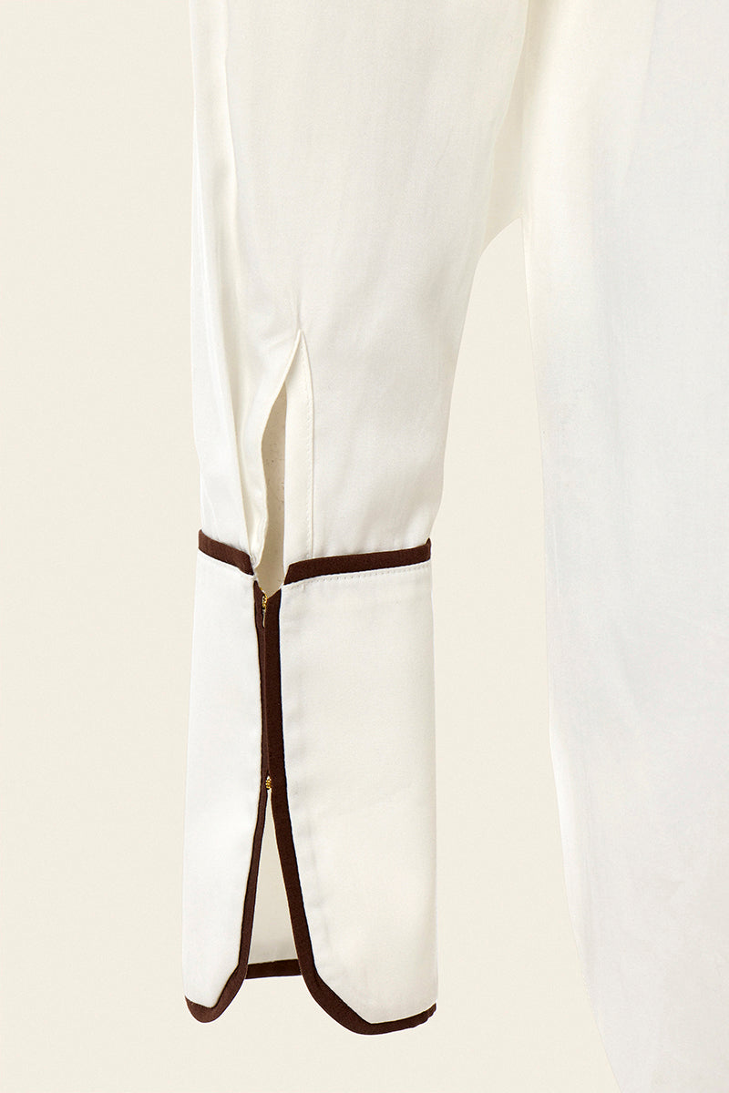 White boyfriend shirt by IKINITA featuring a classic collar and button-down design, displayed on a hanger.