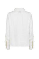 White Señorita Antonia blouse with long sleeves and button-up front, displayed on a hanger against a neutral background.