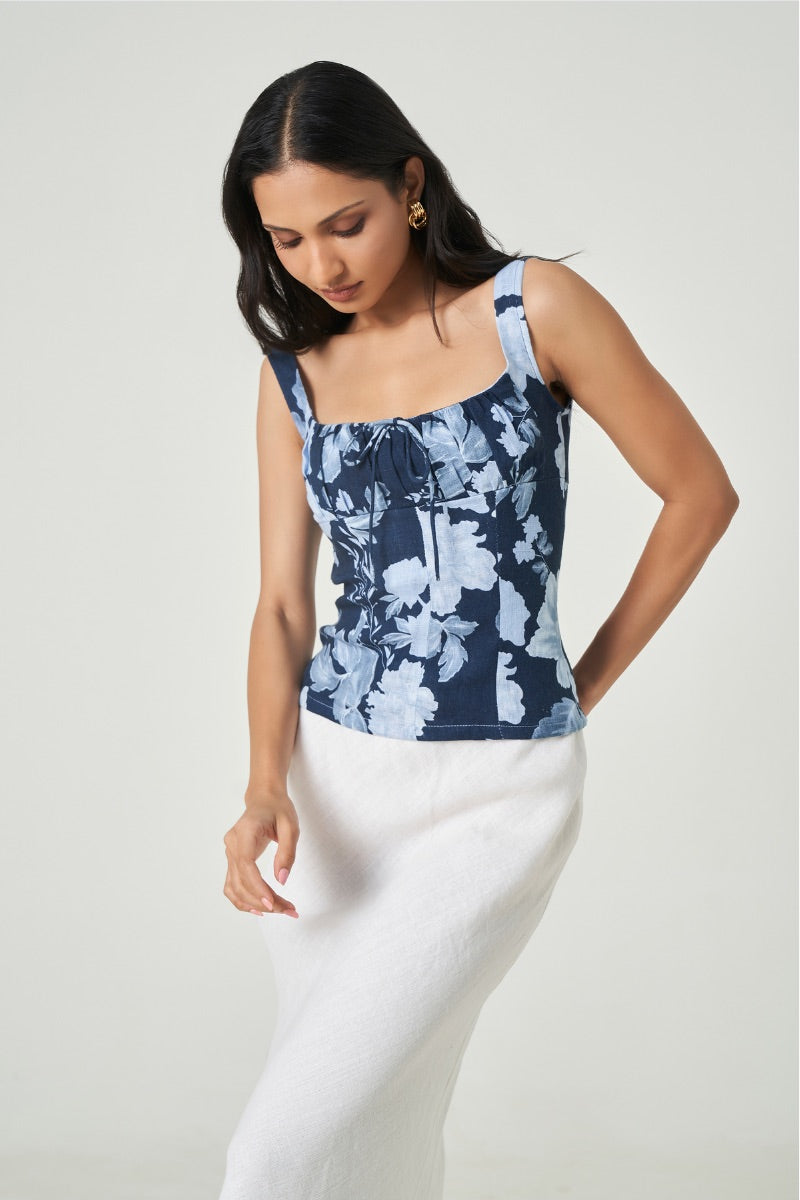 Dark blue Lille top by Summer Away, featuring a stylish sleeveless design, shown on a hanger with a close-up of fabric texture.