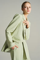 Mint single-breasted blazer by I.H.F Studio with asymmetric design and crystal-embellished pockets, stylish and elegant.