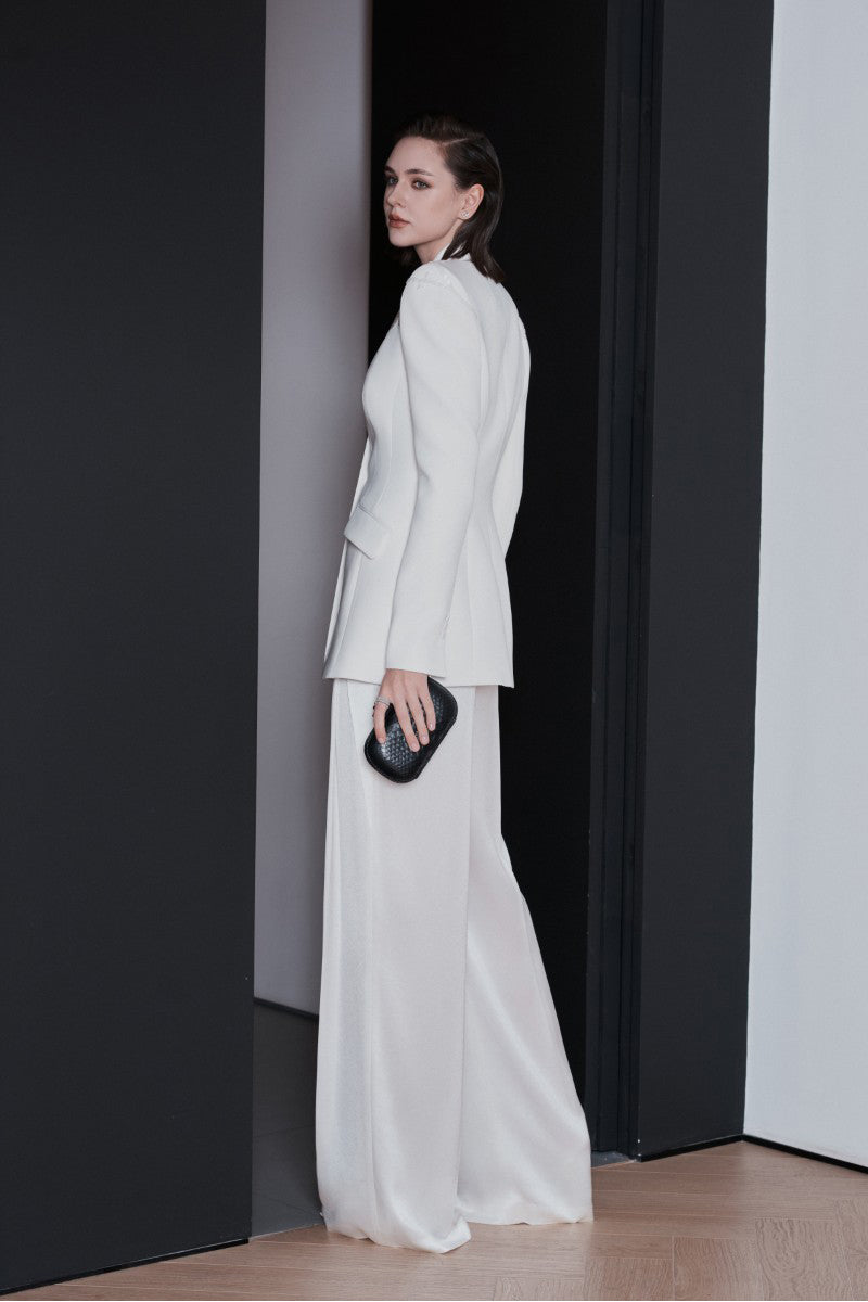 White LEKIEU Venice jacket shown on a hanger, featuring a sleek design with a zip-up front and stylish collar.