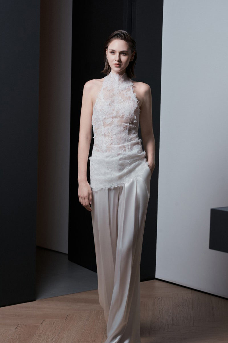 White Bologna top by LEKIEU, featuring a stylish and comfortable design, shown on a model with a close-up of the fabric.