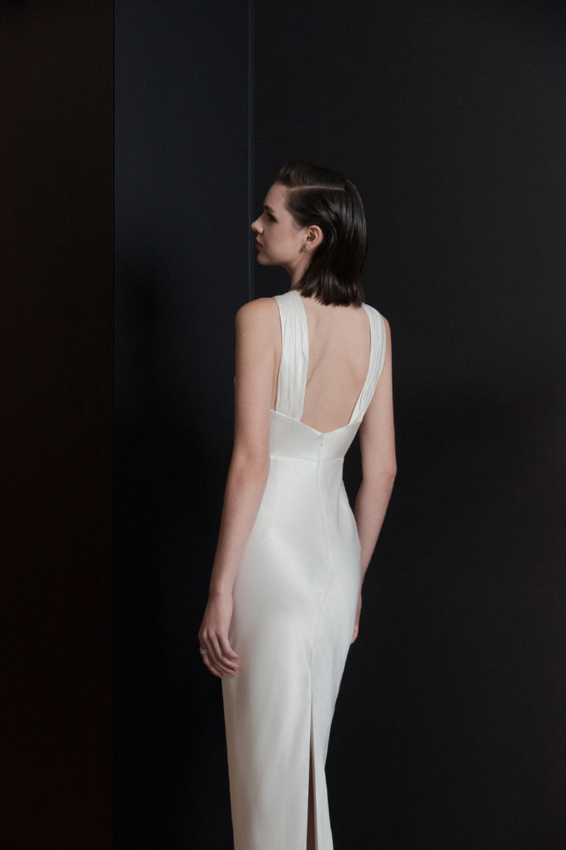 White Catania maxi dress by LEKIEU, flowing fabric, sleeveless design, and elegant silhouette perfect for summer wear.