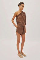 Labeca Capri Cappuccino linen one-sleeve top, stylish and lightweight, shown in a natural fabric finish.