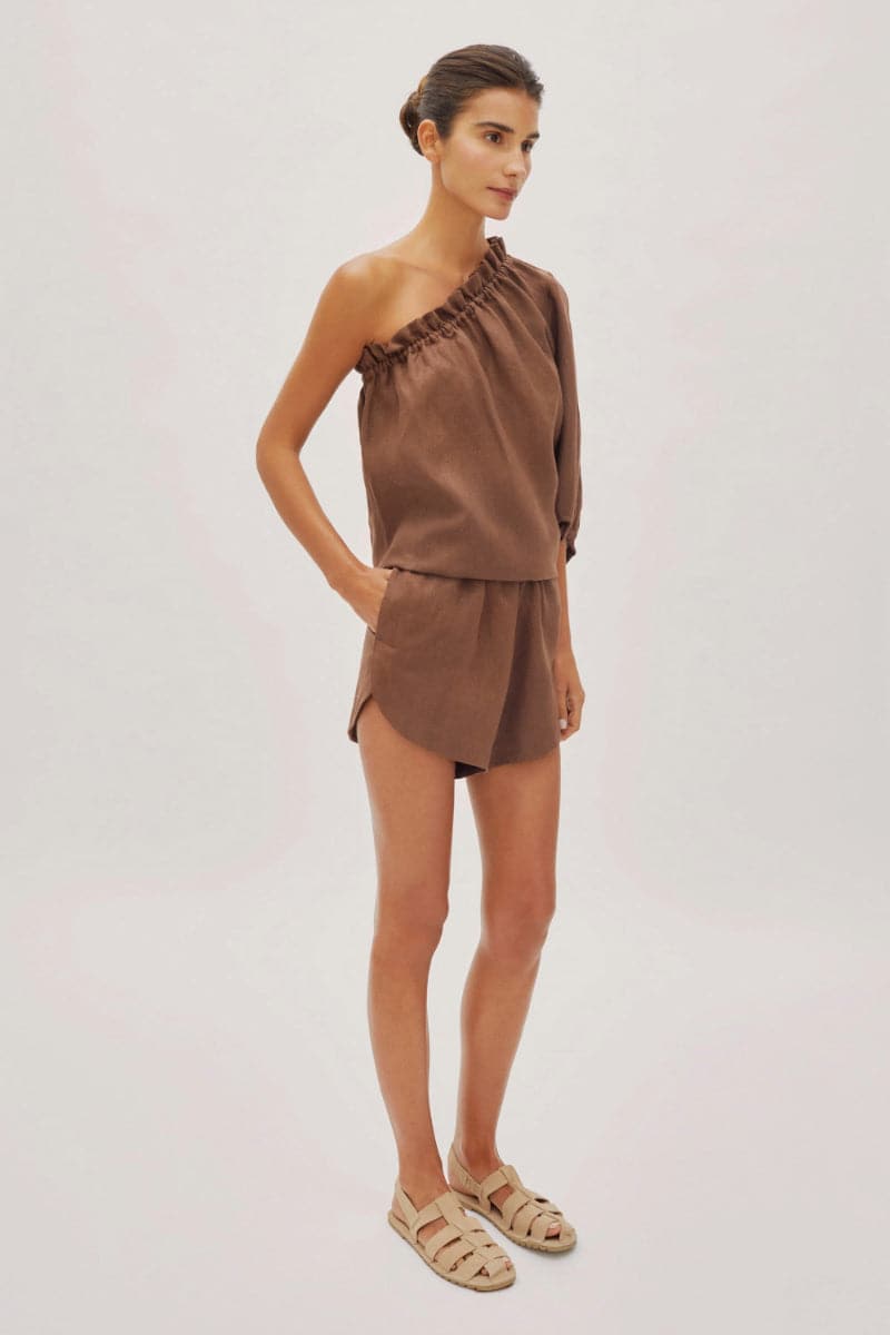 Labeca Capri Cappuccino linen one-sleeve top, stylish and lightweight, shown in a natural fabric finish.