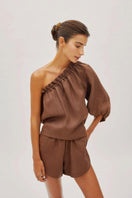 Labeca Capri Cappuccino linen one-sleeve top, stylish and lightweight with a relaxed fit, displayed on a neutral background.