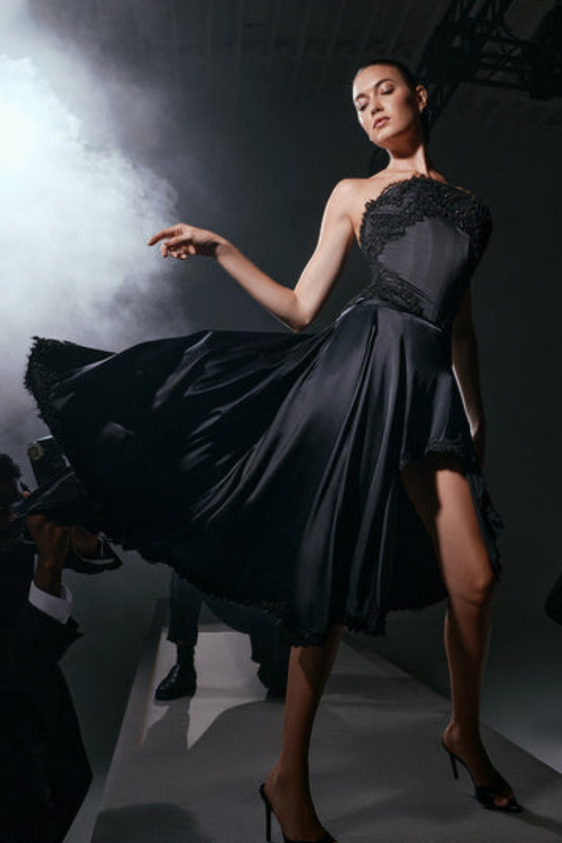 Black Lauren midi skirt by Scarlett Gasque, shown in a stylish, flowing design on a model.