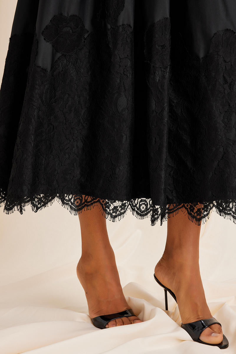 Black Fiorella maxi skirt by Scarlett Gasque, flowing fabric with pleated details and elegant design, suitable for casual or formal wear.