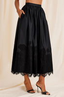 Black Fiorella maxi skirt by Scarlett Gasque shown from the front, featuring flowing fabric and elegant design.