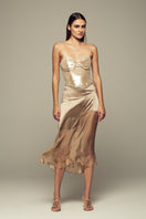 Nude IKINITA Nausica midi skirt, soft fabric, high waist, and flowing silhouette, displayed on a white background.