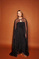 Black floral beaded cape coat by Mastani, featuring intricate beadwork and elegant design, showcased in the image.