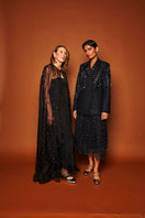 Beaded floral maxi cape in noir by Mastani, featuring intricate beadwork and elegant design, worn as a stylish coat.