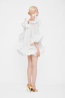 White Valenciani Origami Cloud mini dress displayed on a hanger, showcasing its elegant, lightweight fabric and modern design.