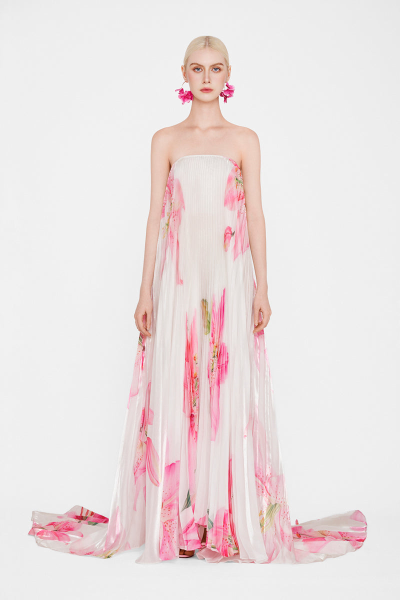 Valenciani CULT MIA X VALENCIANI The Blossom pleated maxi gown displayed on a hanger with flowing fabric and intricate pleats.