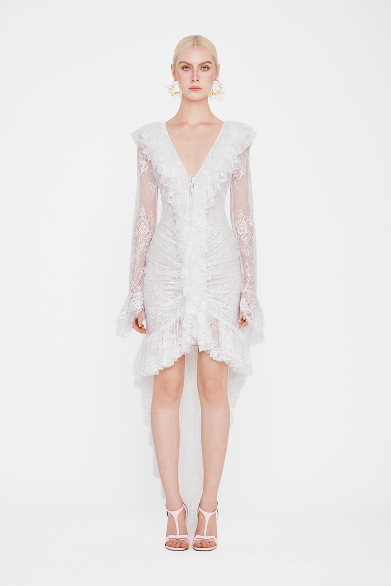 Valenciani Seraphina ruffle high-low white midi dress displayed on a hanger, showcasing its flowing fabric and ruffle details.