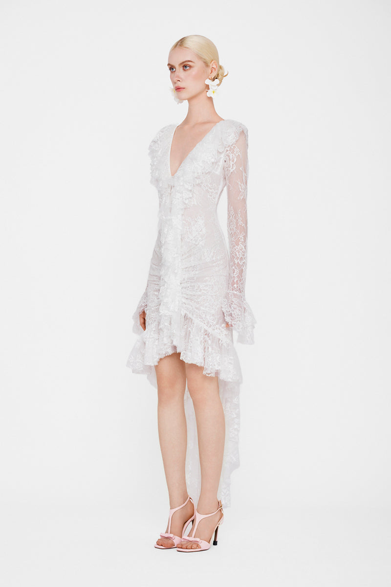 Valenciani Seraphina ruffle high-low white midi dress displayed on a hanger, showcasing its elegant ruffle details and flowing silhouette.