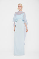 Valenciani Galatea cape gown in ice blue, elegant maxi dress with flowing fabric and stylish cape detail, perfect for formal occasions.