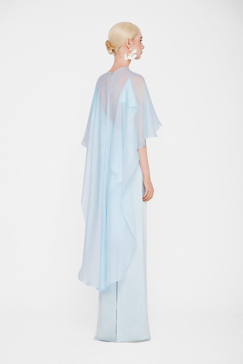Valenciani The Galatea cape gown in ice blue, a flowing maxi dress with elegant cape details, perfect for formal occasions.