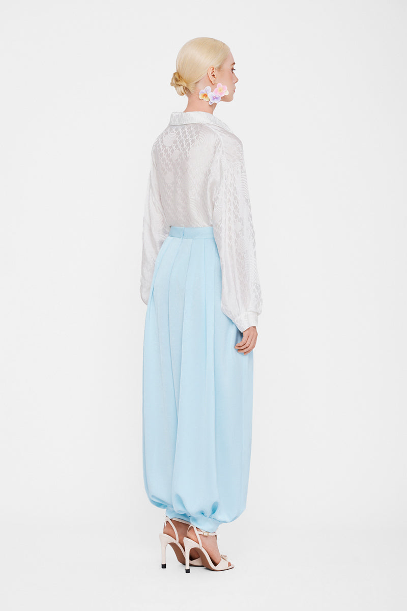 Sky blue balloon pants by Valenciani, featuring a relaxed fit and unique balloon silhouette, displayed on a mannequin.