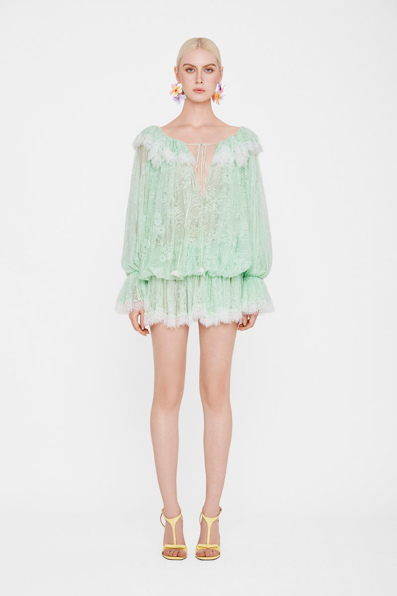 Valenciani off-shoulder lace mini dress displayed on a mannequin, featuring delicate lace fabric and a fitted silhouette.