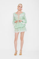Valenciani off-shoulder lace mini dress displayed on a hanger, featuring delicate lace fabric and a stylish, trendy design.