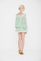 Valenciani off-shoulder lace mini dress displayed on a mannequin with intricate lace details and a fitted silhouette.