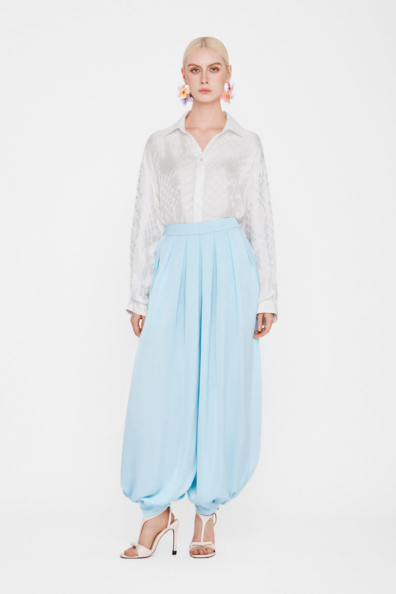 White silk shirt from Valenciani, showcasing smooth fabric and classic collar design.
