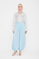 White silk shirt from Valenciani, showcasing smooth fabric and classic collar design.