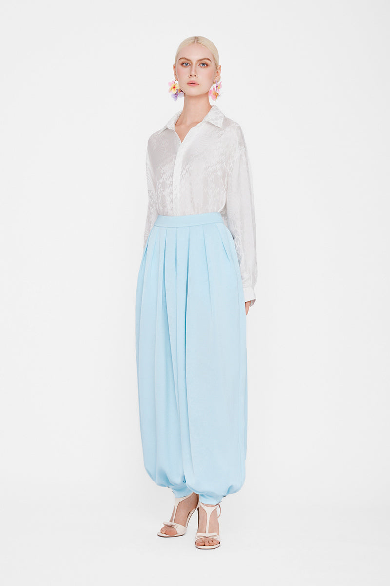 White silk shirt by Valenciani, showcasing a smooth, elegant fabric and classic collar on a casual yet stylish design.