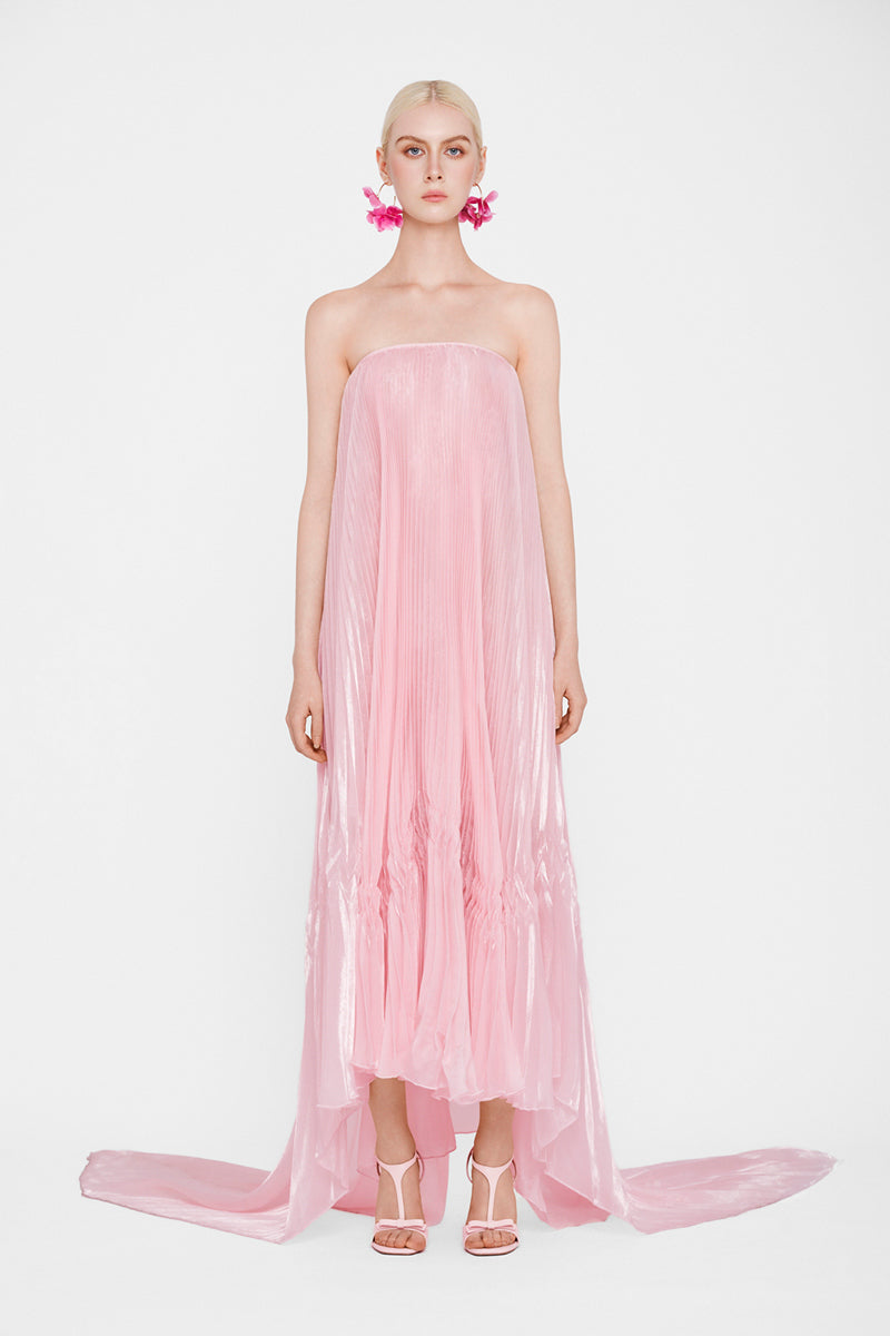 Pastel pink strapless pleated maxi dress by Valenciani, flowing design with elegant pleats, perfect for summer occasions.