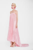 Pastel pink Valenciani strapless pleated maxi dress displayed on a hanger, showcasing flowing fabric and elegant design.