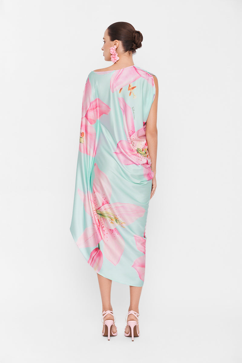 Multicolor asymmetrical drape maxi dress by Valenciani, flowing fabric with unique design, worn as elegant evening wear.