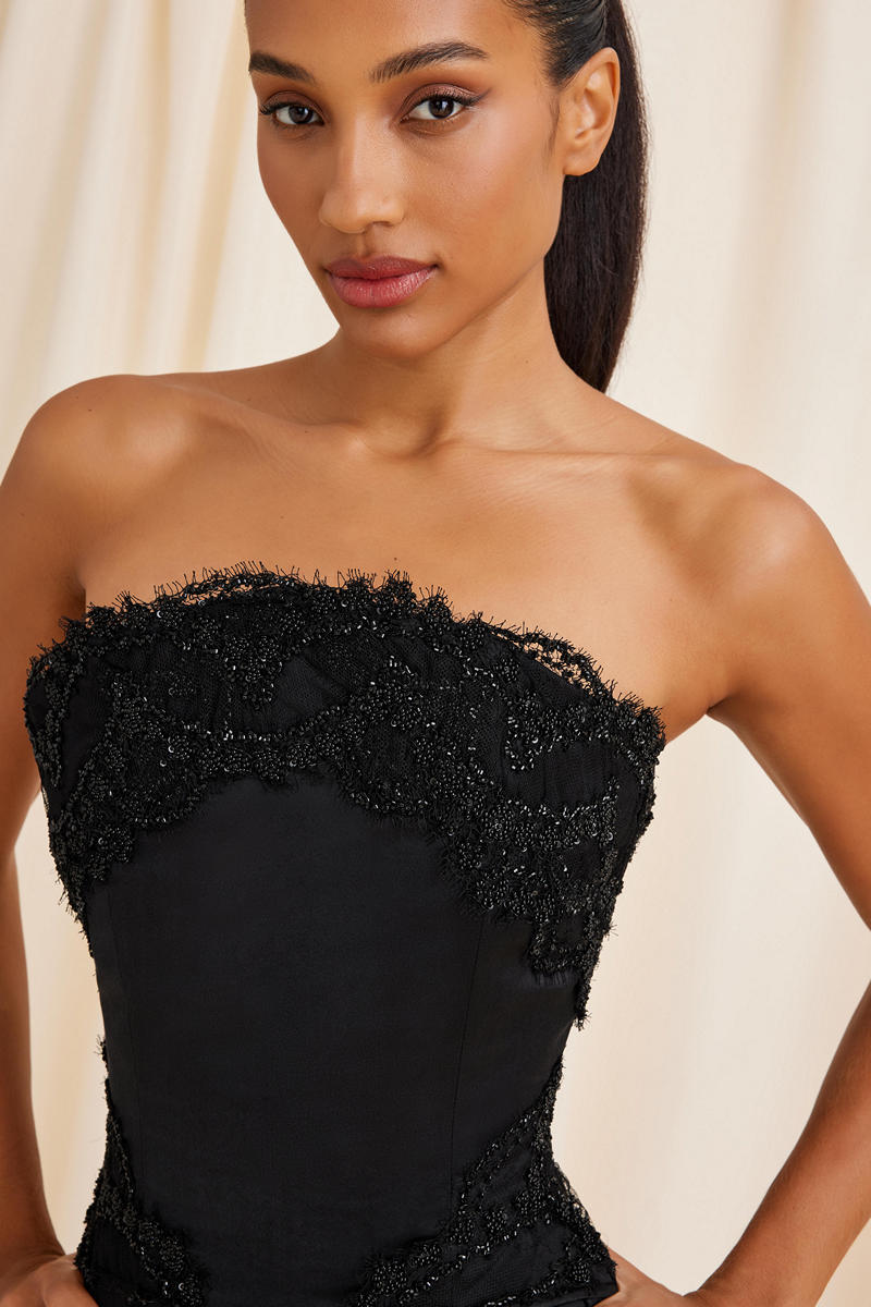 Black Lauren corset top by Scarlett Gasque with lace-up front and fitted design, showcased on a neutral background.