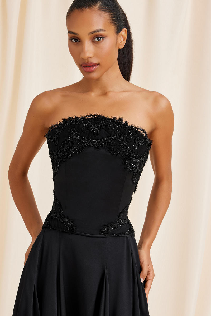 Black Lauren corset top by Scarlett Gasque, featuring structured design and adjustable straps, displayed on a hanger.