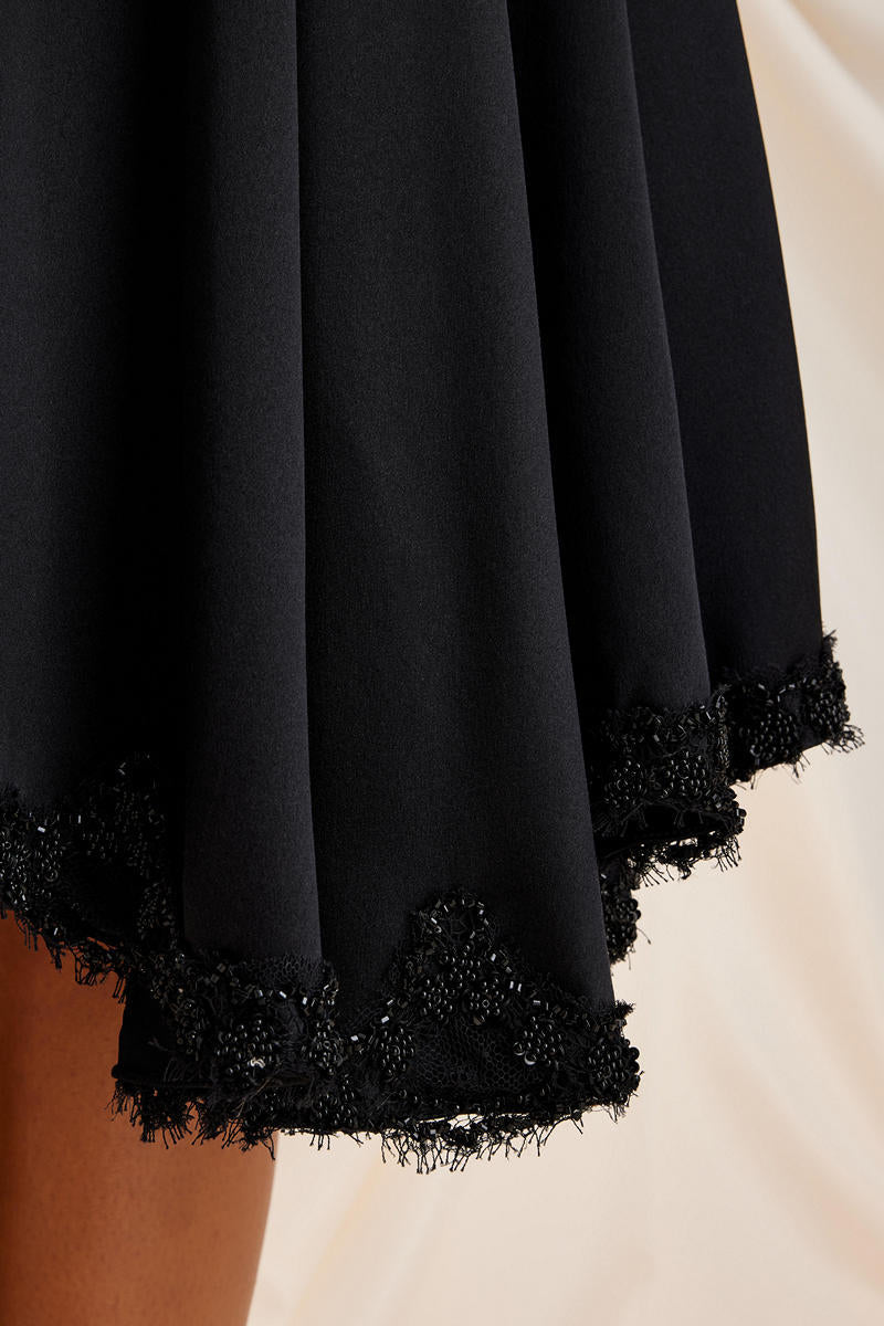 Black Lauren midi skirt by Scarlett Gasque, featuring a sleek, tailored design with detailed stitching and a fitted waist.