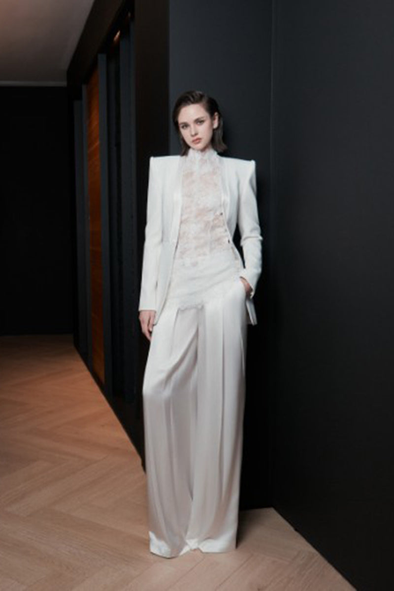 White LEKIEU CAEN pants shown on a model, featuring a relaxed fit and stylish design in a casual clothing style.
