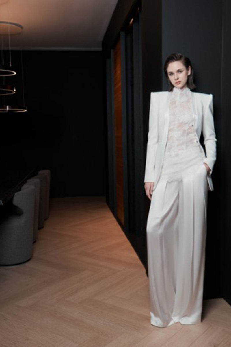 White LEKIEU Florence jacket displayed on a hanger, showcasing its sleek design and smooth fabric.