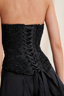 Black Lauren corset top by Scarlett Gasque with lace-up front and structured design on a neutral background.