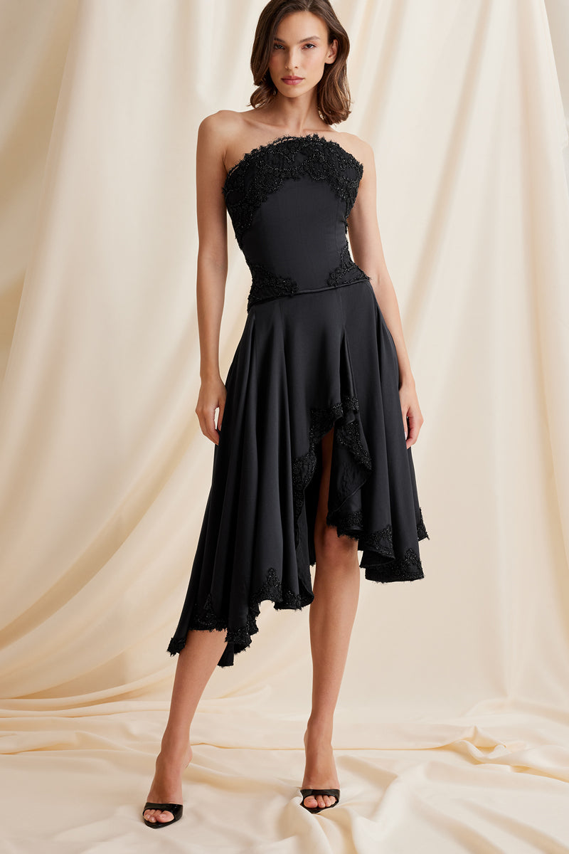 Black Lauren skirt by Scarlett Gasque, midi length with smooth fabric and stylish design, shown in a close-up photo.